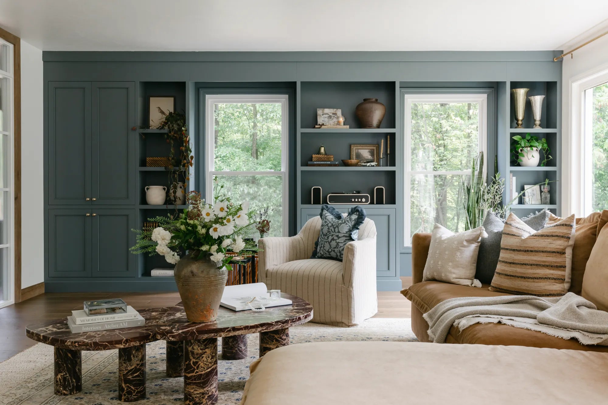 Living Room Design and Styling by S. Flynn Home showcasing textured throw pillows, throw blankets, candles, vases, and framed artwork. 